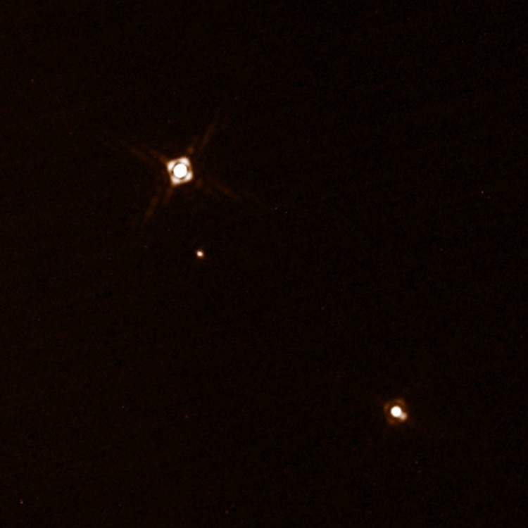 Imagem do Sphere mostra o planeta HD 131399Ab, o mais tênue dos objetos. Acima, a estrela principal e mais brilhante; abaixo, o par de estrelas menores. (Crédito: ESO)